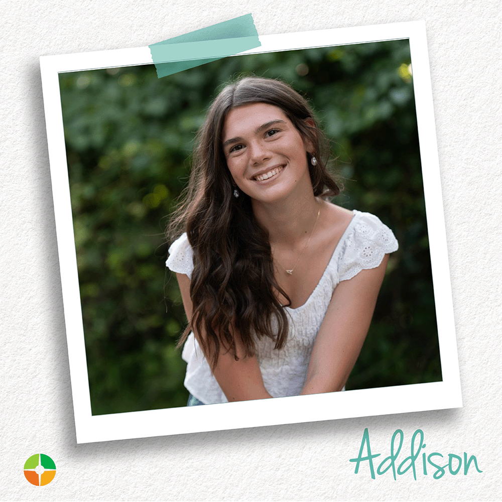 A young woman with long dark hair smiles warmly while seated outdoors against a backdrop of lush greenery. Wearing a white blouse and simple jewelry, she poses naturally, creating a bright and cheerful portrait with a relaxed, approachable feel. A young woman with long dark hair smiles warmly while seated outdoors against a backdrop of lush greenery. Wearing a white blouse and simple jewelry, she poses naturally, creating a bright and cheerful portrait with a relaxed, approachable feel.