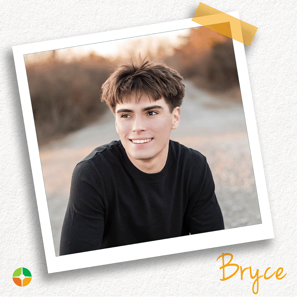Polaroid-style photo of a smiling young man with short brown hair sitting outdoors on a path at sunset. He wears a black long-sleeve shirt and looks off to the side. The name “Bryce” appears in orange script at the bottom, with a small logo in the corner.
