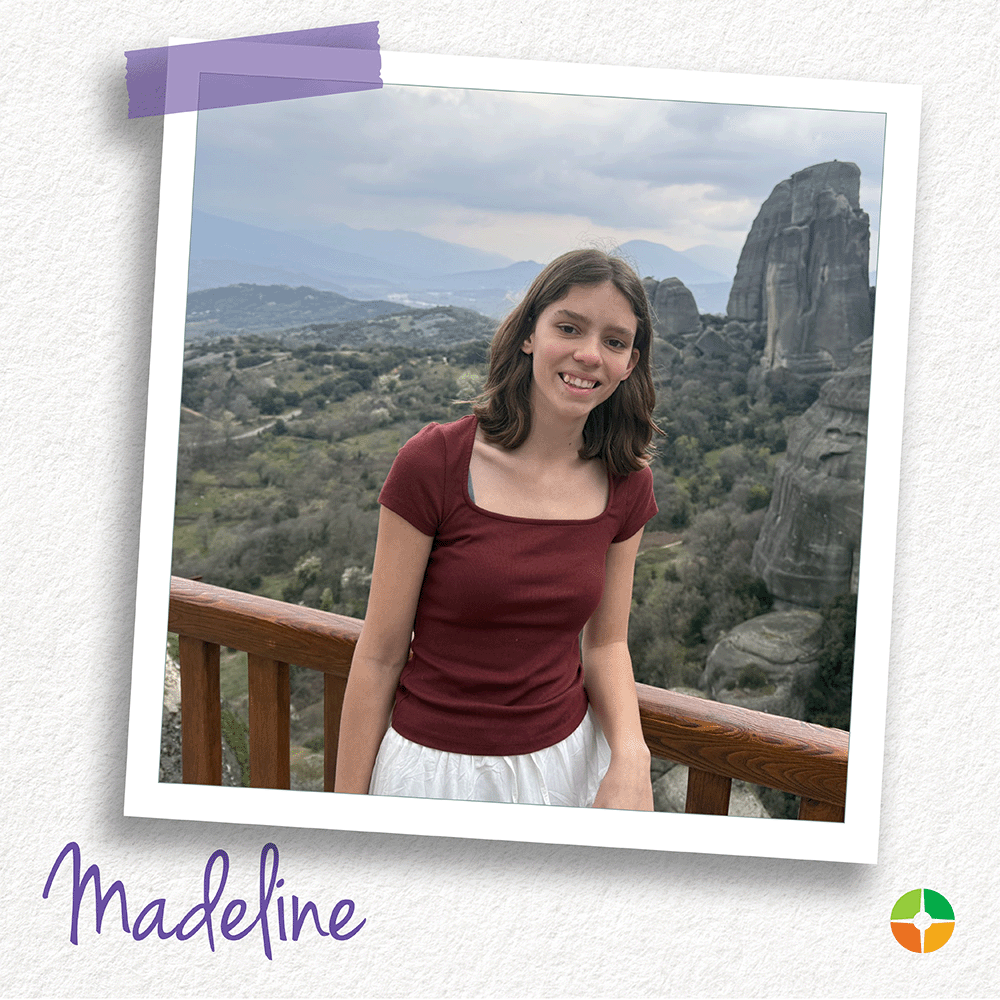 A young woman smiles while standing at a scenic overlook with dramatic rock formations and rolling hills in the background. Wearing a burgundy top and light skirt, she poses against a railing, capturing a memorable moment during her travels. A young woman smiles while standing at a scenic overlook with dramatic rock formations and rolling hills in the background. Wearing a burgundy top and light skirt, she poses against a railing, capturing a memorable moment during her travels.