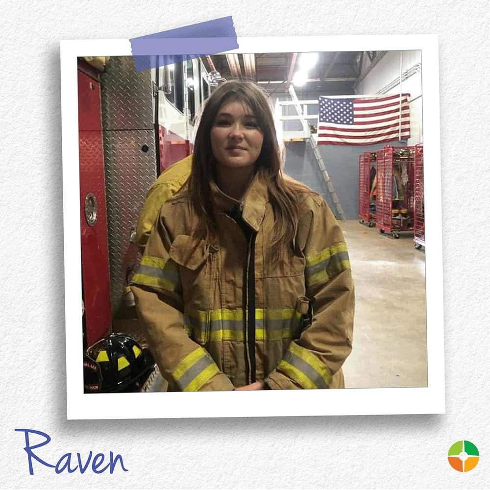 A senior portrait-style photo of Raven standing in firefighter turnout gear inside a fire station. A fire truck, firefighter equipment, and an American flag are visible in the background, highlighting her interest in fire service and community protection. A senior portrait-style photo of Raven standing in firefighter turnout gear inside a fire station. A fire truck, firefighter equipment, and an American flag are visible in the background, highlighting her interest in fire service and community protection.