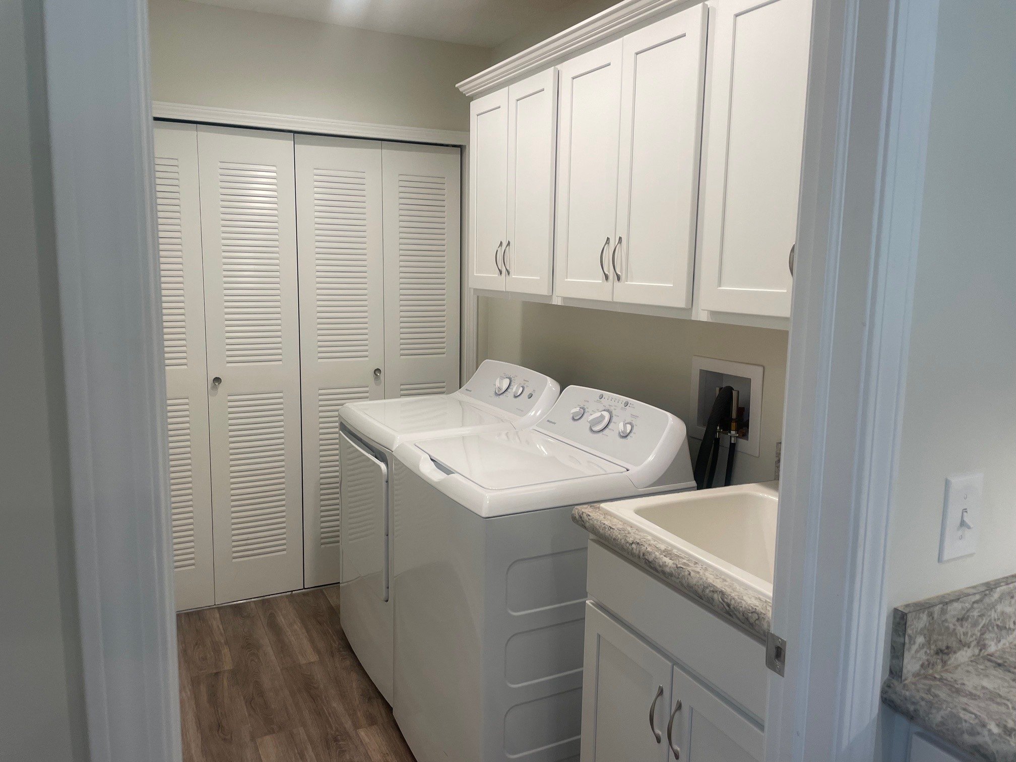 Laundry room with storage and utility sink